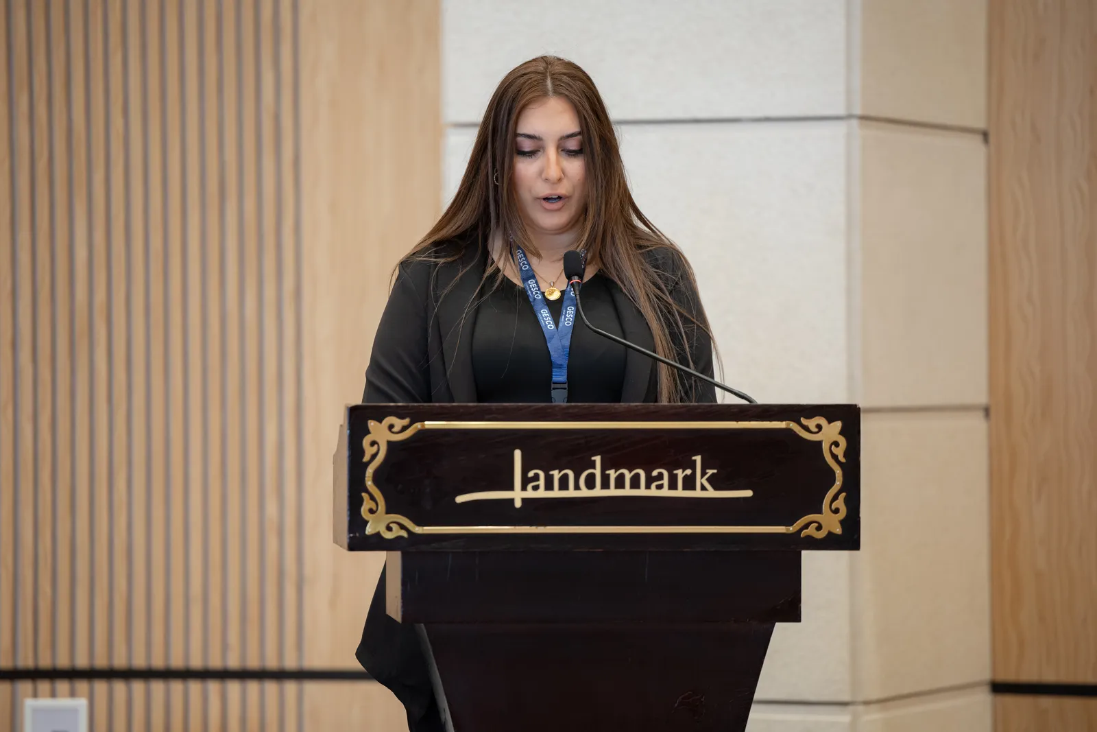 A member of the GESCO team speaking at the podium during the opening of the 28th GESCO Education Fair