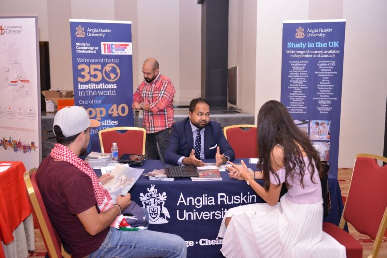 The Anglia Ruskin University stand, with a representative meeting a student