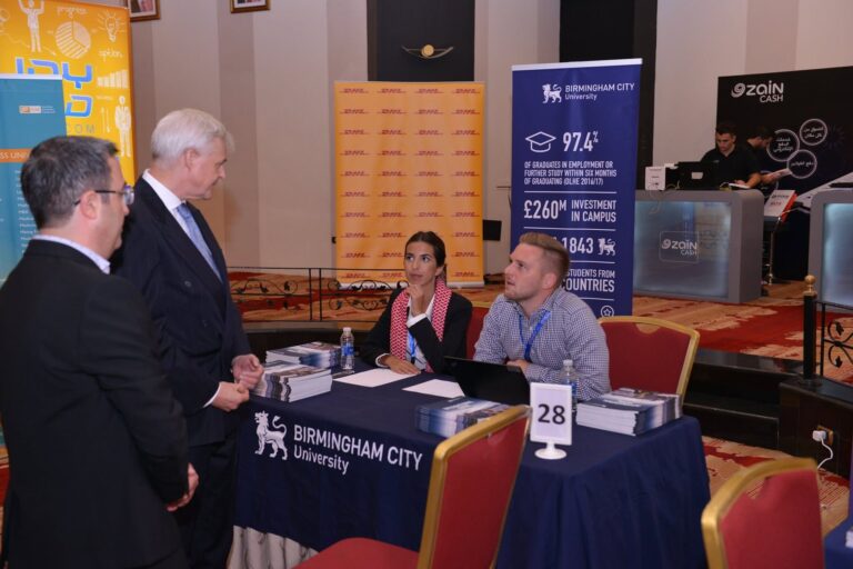 University representatives meeting visitors at their stand