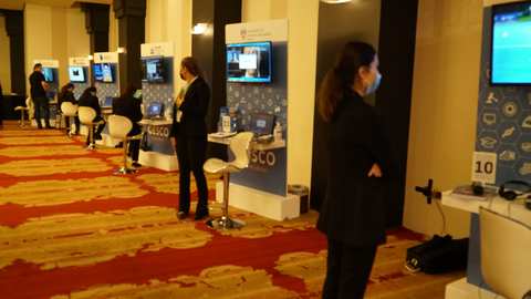 University booths and visitors on the floor of a previous GESCO education fair